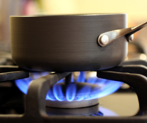 A pot sitting on a gas-powered stove burner