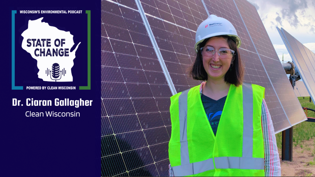 Ciaran Gallaher, PhD, stands in front of Sherco Solar Farm in Minnesota